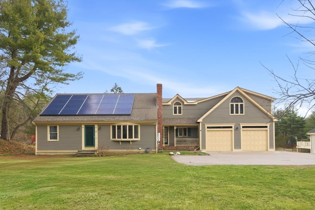 64 Village Street Millis, MA 02054 - Photo 2 of 41 a front view of a house with a garden