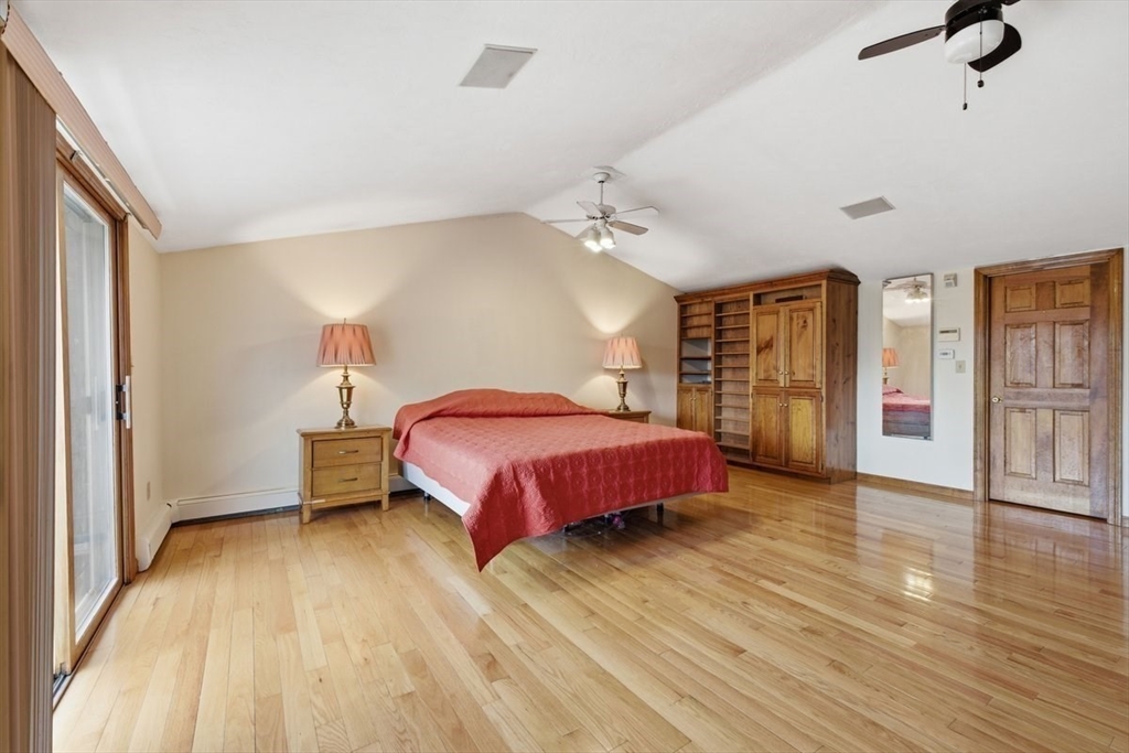 64 Village Street Millis, MA 02054 - Photo 21 of 41 a spacious bedroom with a bed and wooden floor