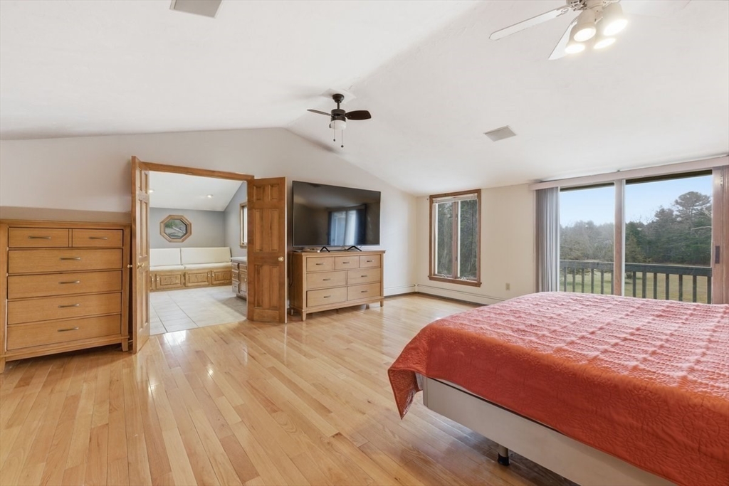 64 Village Street Millis, MA 02054 - Photo 22 of 41 a bedroom with a large bed and wooden floor