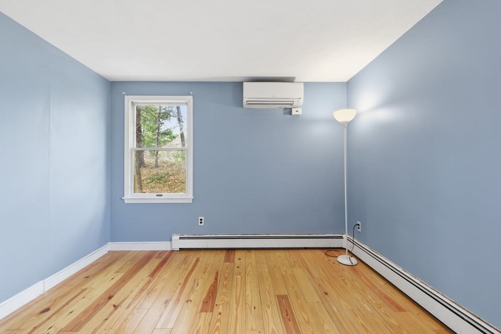 64 Village Street Millis, MA 02054 - Photo 33 of 41 a view of an empty room with window and wooden floor