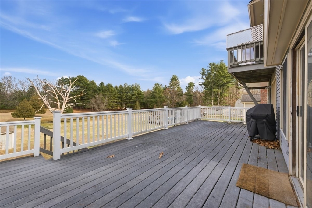 64 Village Street Millis, MA 02054 - Photo 35 of 41 a view of a balcony with wooden floor and iron fence