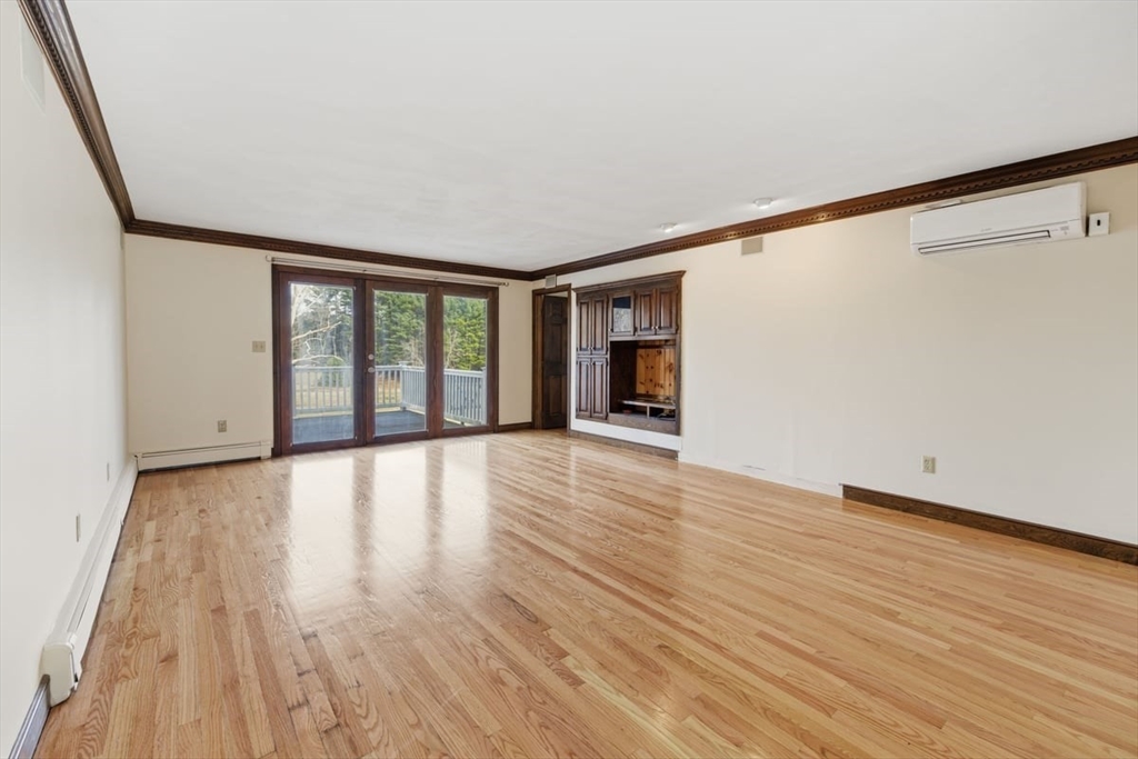 64 Village Street Millis, MA 02054 - Photo 10 of 41 a view of an empty room with wooden floor and a window