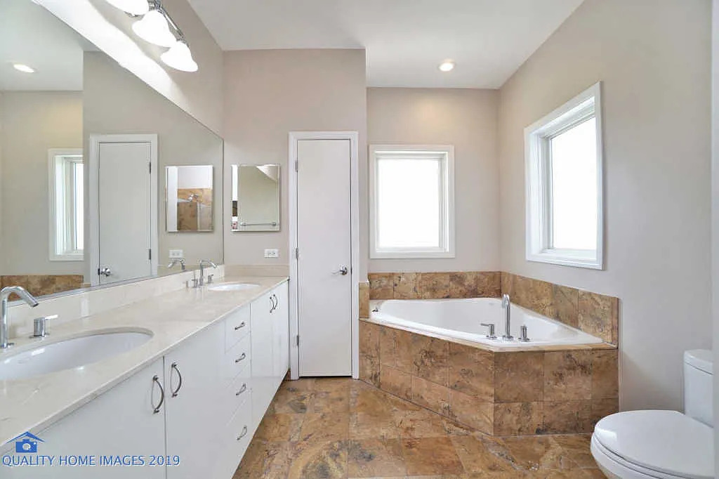 1501 South Prairie Avenue, Unit 1 Chicago, IL 60605 - Photo 14 of 23 a bathroom with a granite countertop sink mirror bathtub and toilet