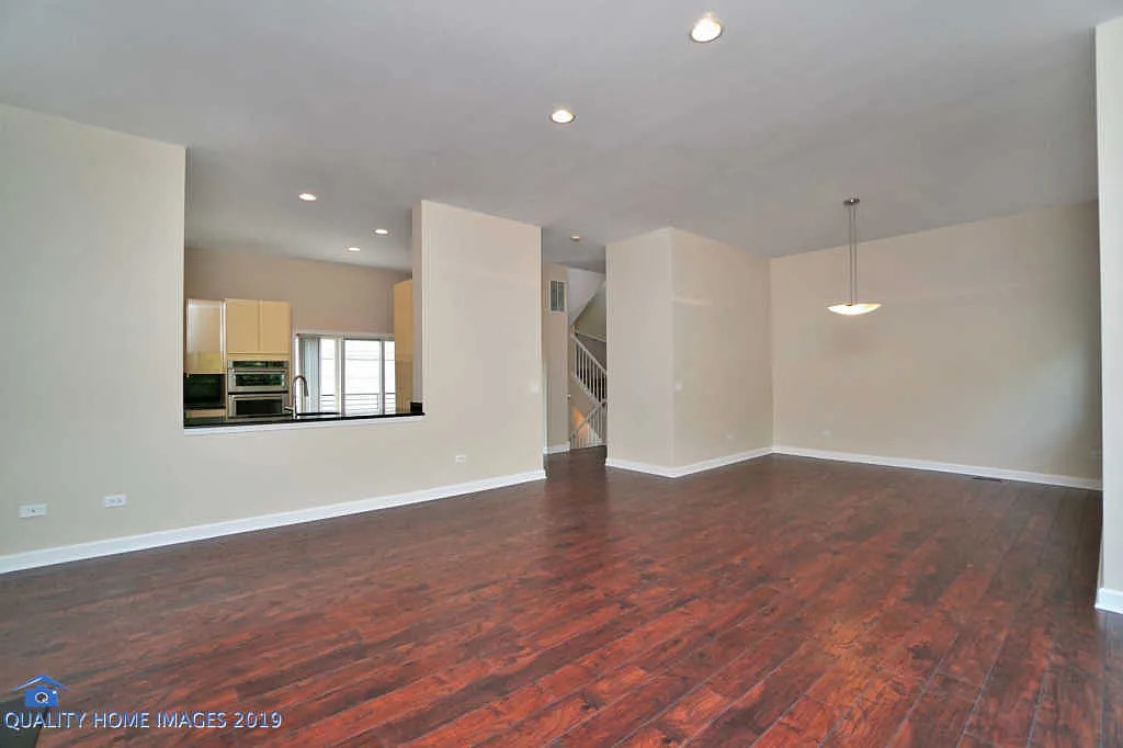 1501 South Prairie Avenue, Unit 1 Chicago, IL 60605 - Photo 4 of 23 a view of an empty room with wooden floor and a window