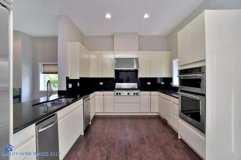 1501 South Prairie Avenue, Unit 1 Chicago, IL 60605 - Photo 6 of 23 a kitchen with granite countertop white cabinets and white appliances