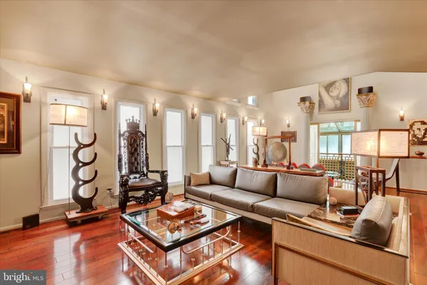 a living room with furniture and a floor to ceiling window