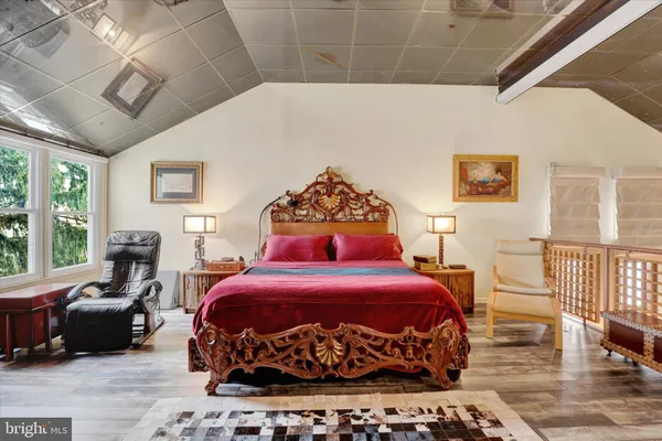 a bed room with a bed and a chair