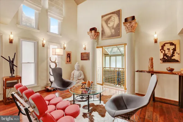 a living room with furniture kitchen view and a flat screen tv