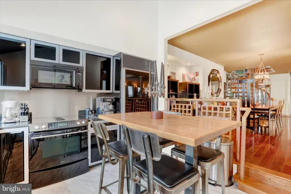 a kitchen with a dining table chairs and window