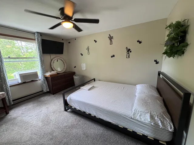 a bedroom with furniture and a flat screen tv