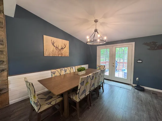 a view of a dining room with furniture wooden floor and chandelier
