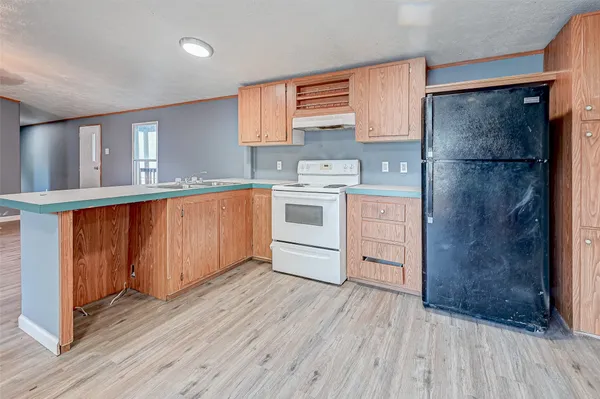 a kitchen with a refrigerator and a sink