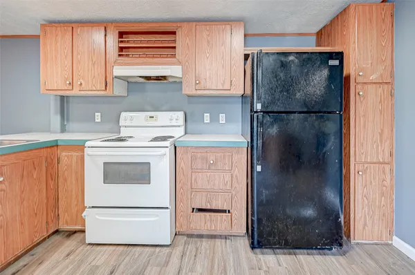 a kitchen with white cabinets and white appliances