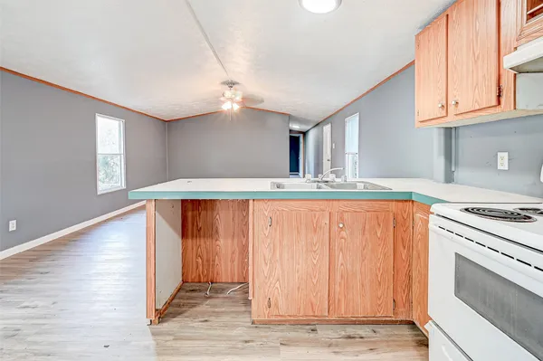 a view of kitchen with granite countertop cabinets and wooden floor