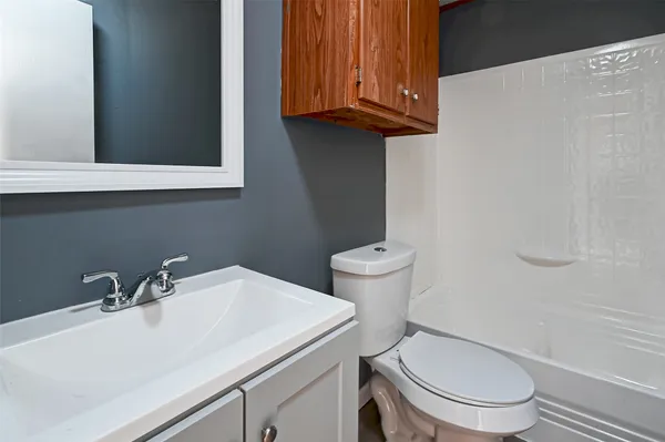 a bathroom with a sink a toilet and mirror