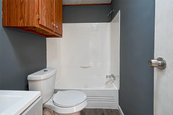a bathroom with a toilet a sink and bathtub