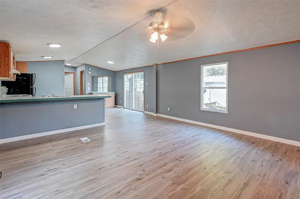a view of a kitchen with wooden floor and a kitchen