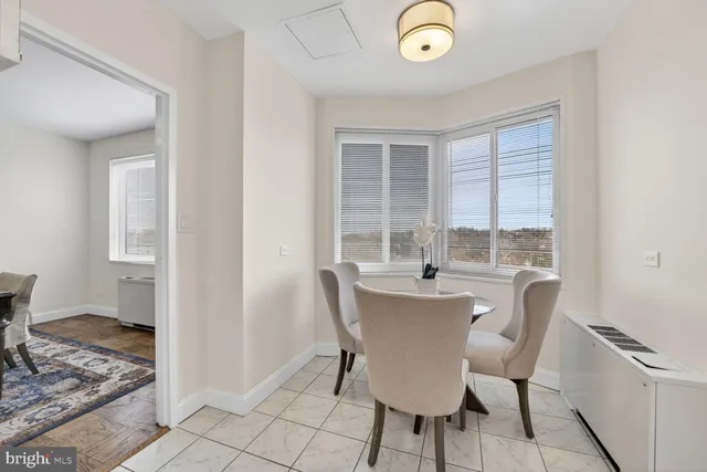 a dining room with furniture and window