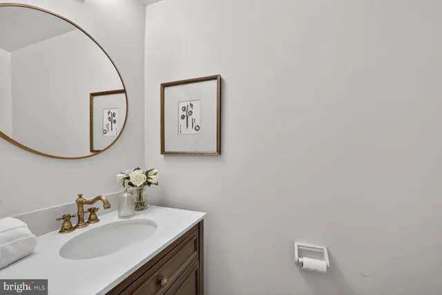 a bathroom with a sink vanity and a mirror