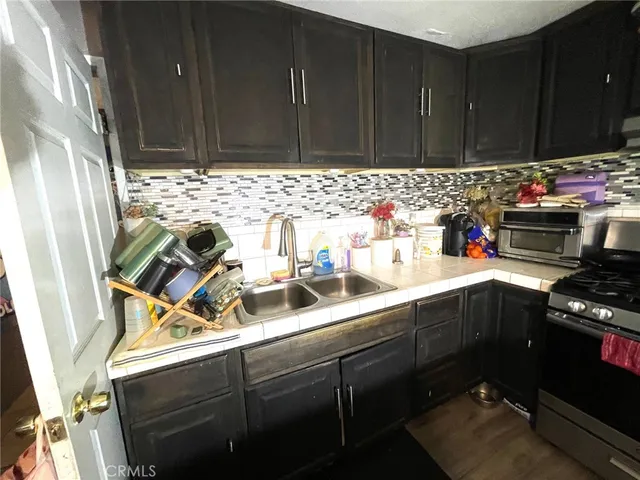 a kitchen with sink cabinets and utility