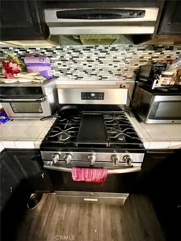 a kitchen with a stove and a microwave