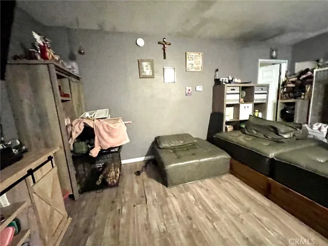 a bedroom with a bed and a flat tv screen on the dresser