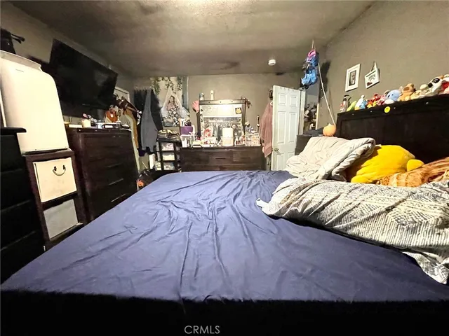 a bed sitting in a bedroom next to a window