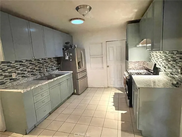 a kitchen with stainless steel appliances granite countertop a sink and cabinets