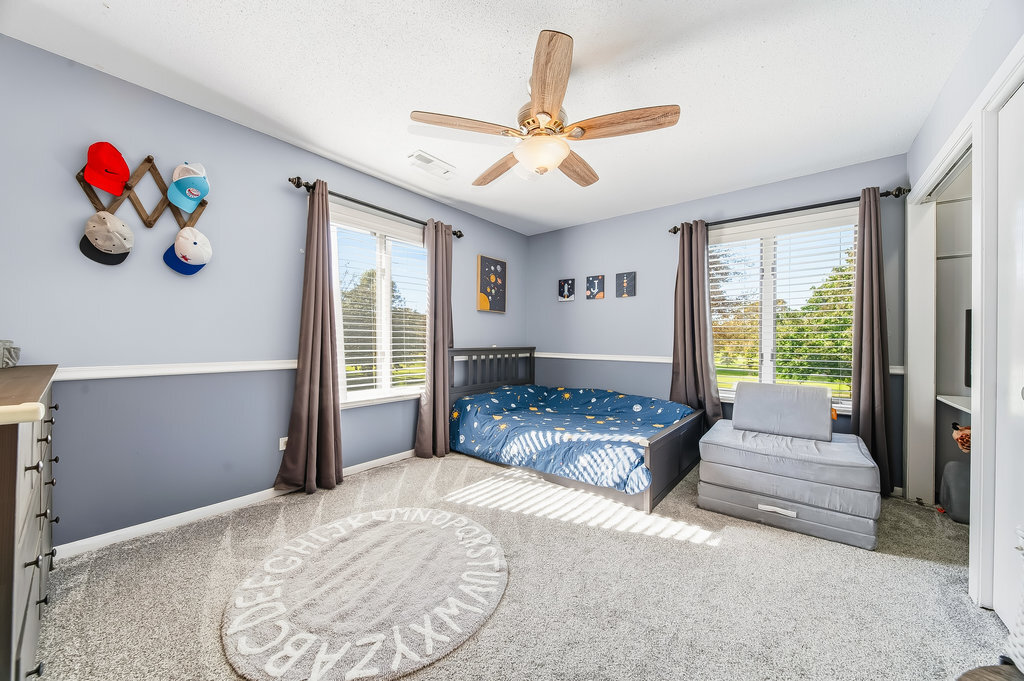 90 Golfview Lane, Unit D Frankfort, IL 60423 - Photo 18 of 27 a bedroom with a bed and a large window