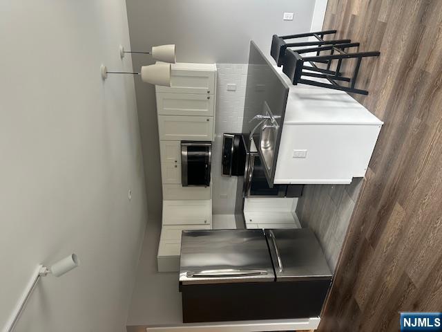 a kitchen with granite countertop a refrigerator a stove a sink and a microwave