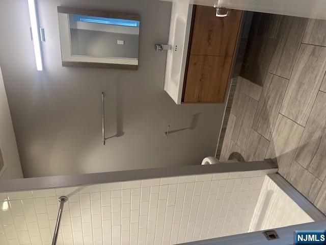 116 Washington Street, Unit 3D Newark, NJ 07102 - Photo 6 of 12 a bathroom with a sink a toilet and shower