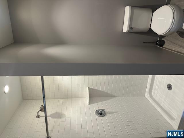 116 Washington Street, Unit 3D Newark, NJ 07102 - Photo 7 of 12 a white toilet sitting next to a bath tub and shower