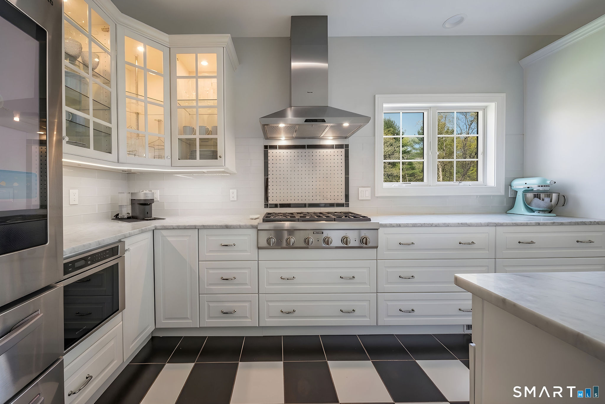 9 Sunset Ridge Drive Guilford, CT 06437 - Photo 5 of 40 a kitchen with a stove oven and white cabinets