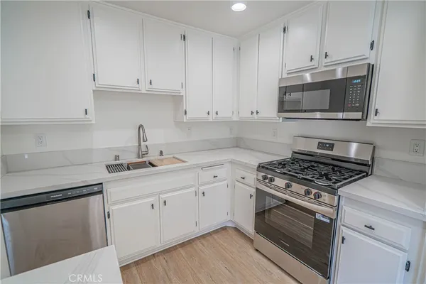 a kitchen with cabinets appliances and a sink