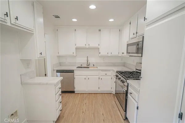 a kitchen with a stove a sink and a refrigerator