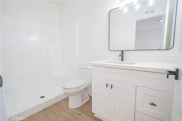 a bathroom with a sink toilet and mirror