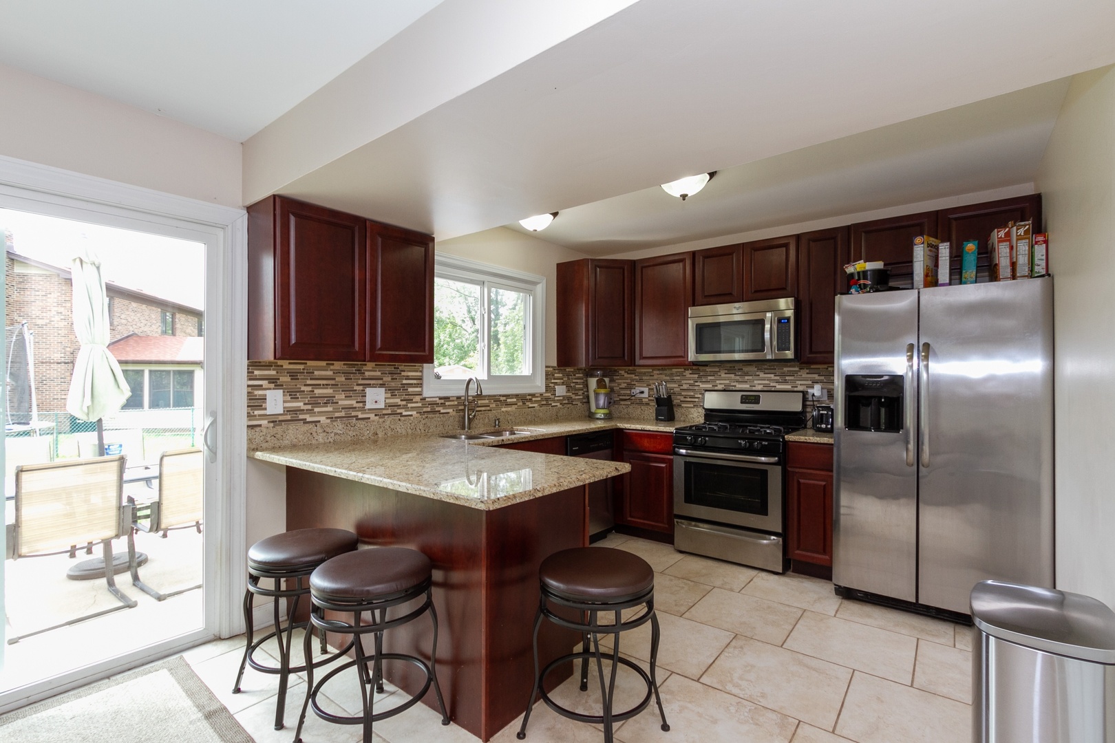29 Pheasant Road Matteson, IL 60443 - Photo 3 of 10 a kitchen with stainless steel appliances granite countertop a refrigerator and a stove top oven
