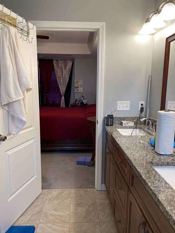 1289 Bay Street Springfield, MA 01109 - Photo 8 of 8 a bathroom with a granite countertop sink and a mirror