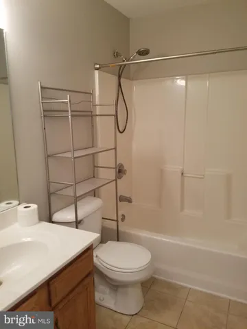a bathroom with a toilet a sink and shower
