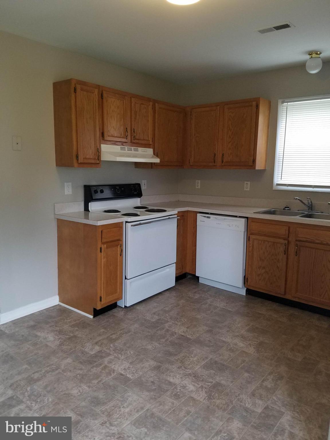 1776 Birch Drive Culpeper, VA 22701 - Photo 5 of 12 a kitchen with stainless steel appliances granite countertop a stove sink and cabinets