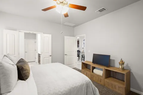 a bedroom with a bed and a television