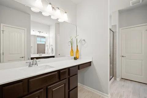 a bathroom with a sink a mirror and vanity