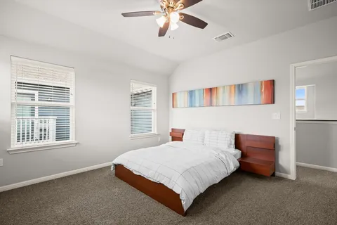 a bedroom with a bed and window