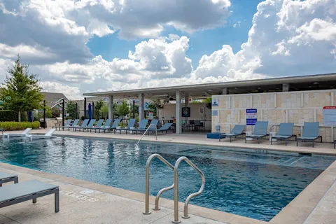a view of a swimming pool and lounge chair