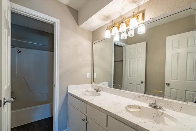 a bathroom with a sink double vanity and a mirror
