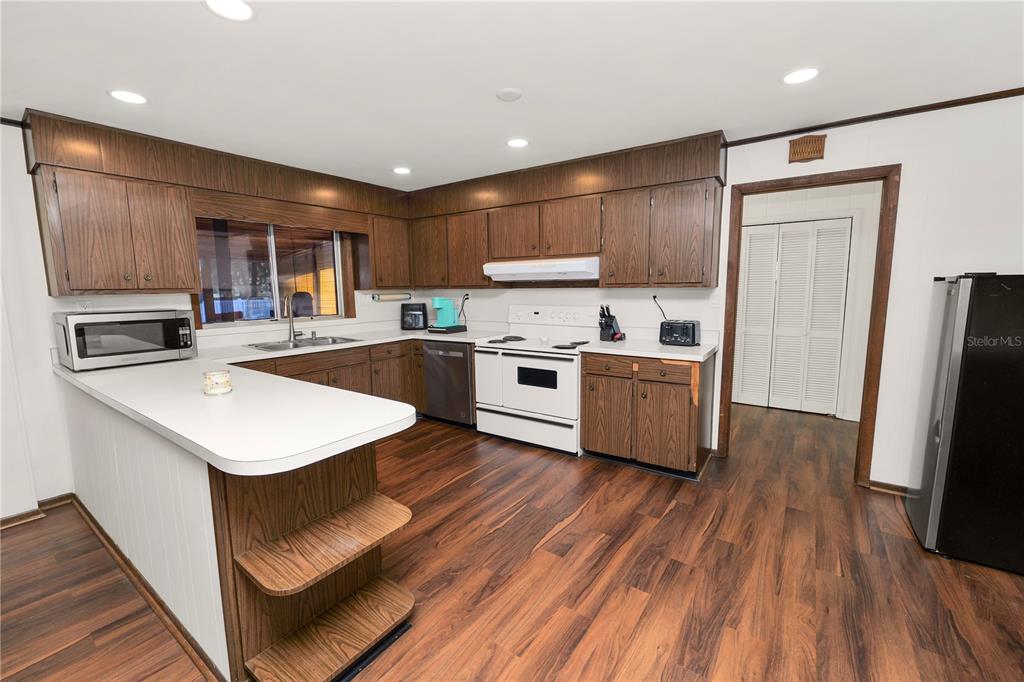 4615 Old Polk City Road Lakeland, FL 33809 - Photo 14 of 71 a kitchen with a sink a counter top space stainless steel appliances and cabinets