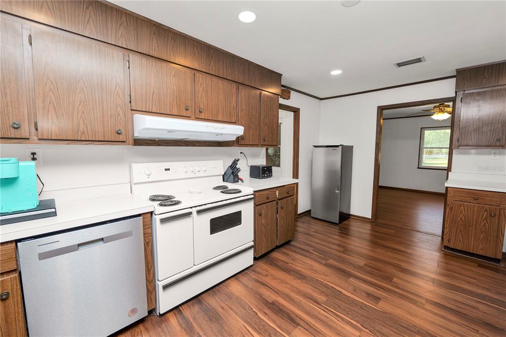 4615 Old Polk City Road Lakeland, FL 33809 - Photo 15 of 71 a kitchen with a sink a refrigerator and cabinets