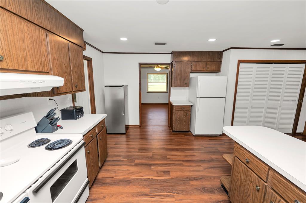 4615 Old Polk City Road Lakeland, FL 33809 - Photo 17 of 71 a kitchen with a refrigerator a stove and wooden floor