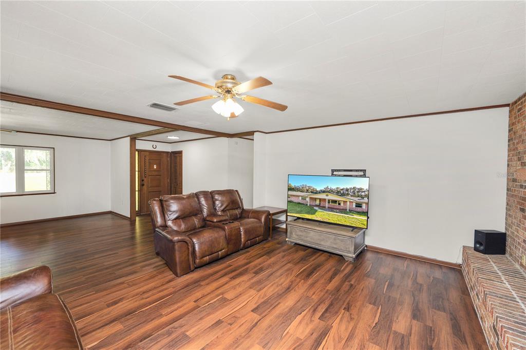 4615 Old Polk City Road Lakeland, FL 33809 - Photo 20 of 71 a living room with furniture and a wooden floor