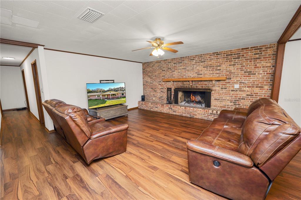 4615 Old Polk City Road Lakeland, FL 33809 - Photo 21 of 71 a living room with furniture and a fireplace